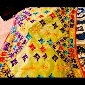 Hand embroidered Indian shawl with vibrant colors.